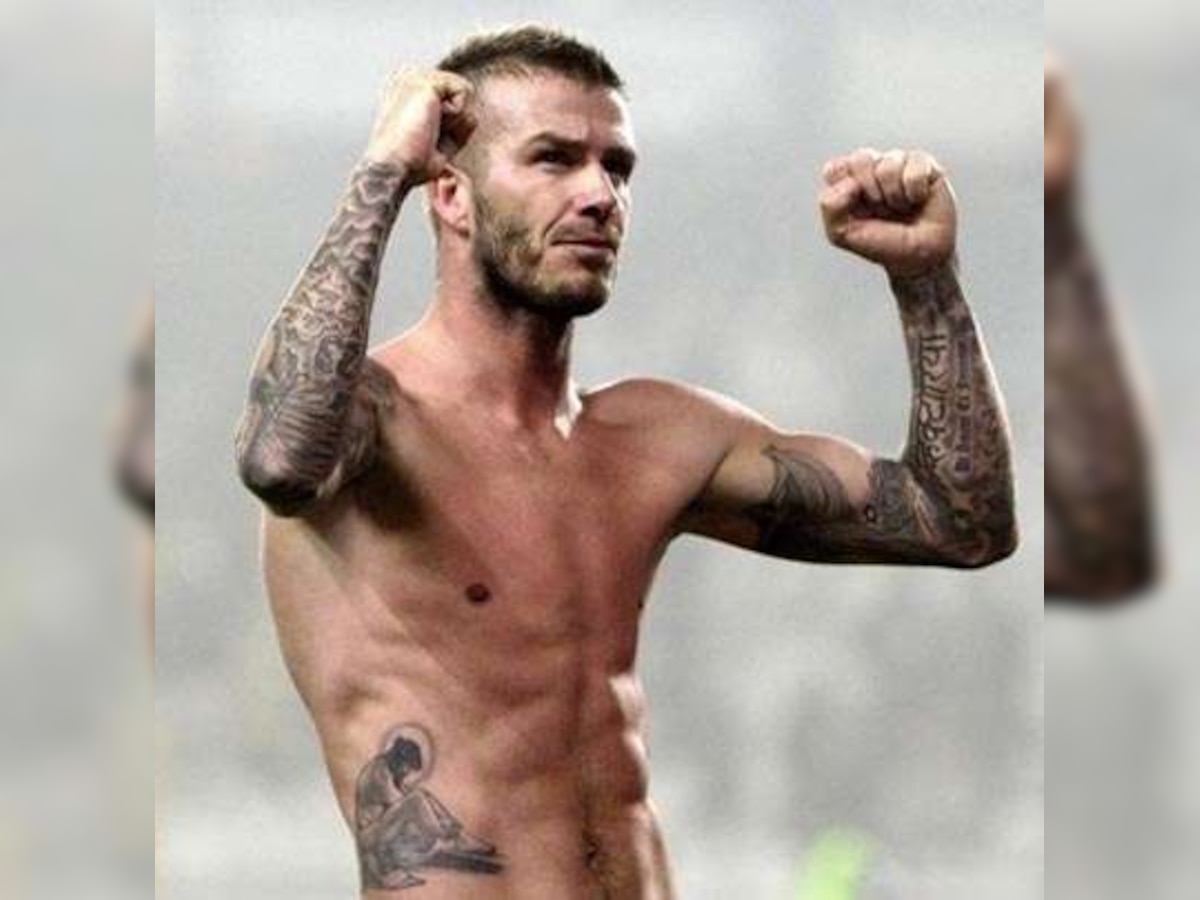 Bare-chested David Beckham shows off new Jesus tattoo