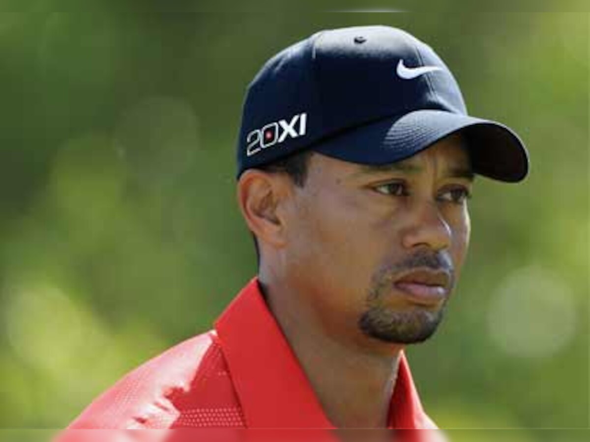 Tiger Woods puts on happy face before snapping at British foes