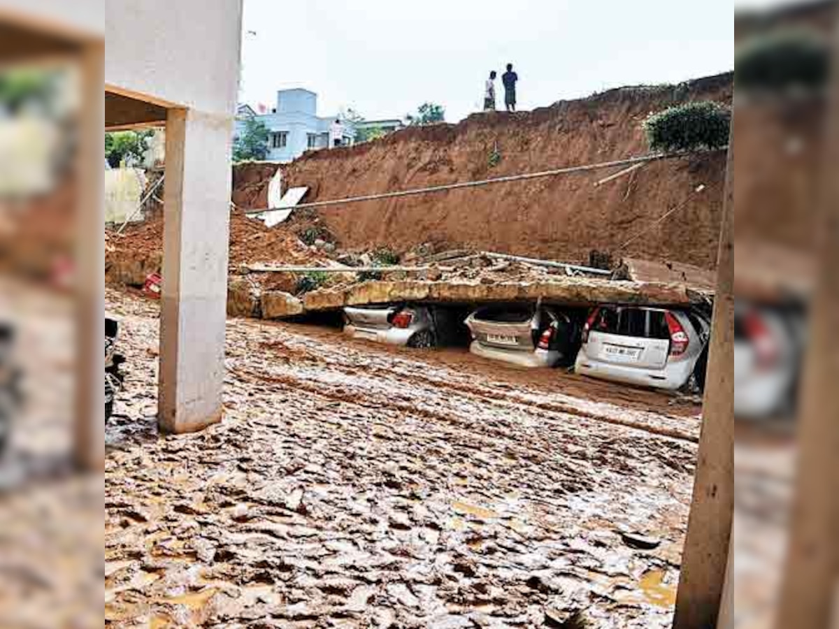 Apartment compound wall crashes; crushes cars