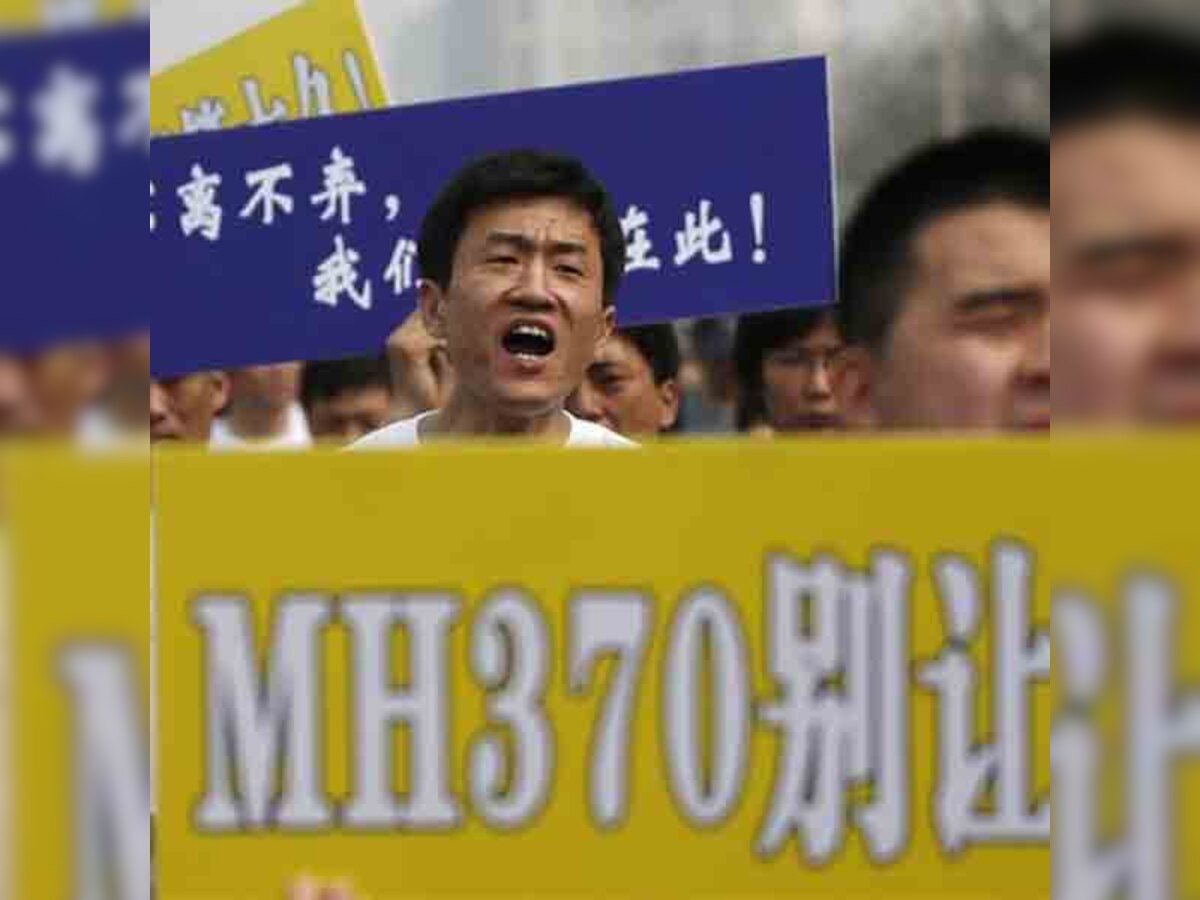 Relatives of passengers on missing jet MH370 protest outside Malaysian embassy in Beijing