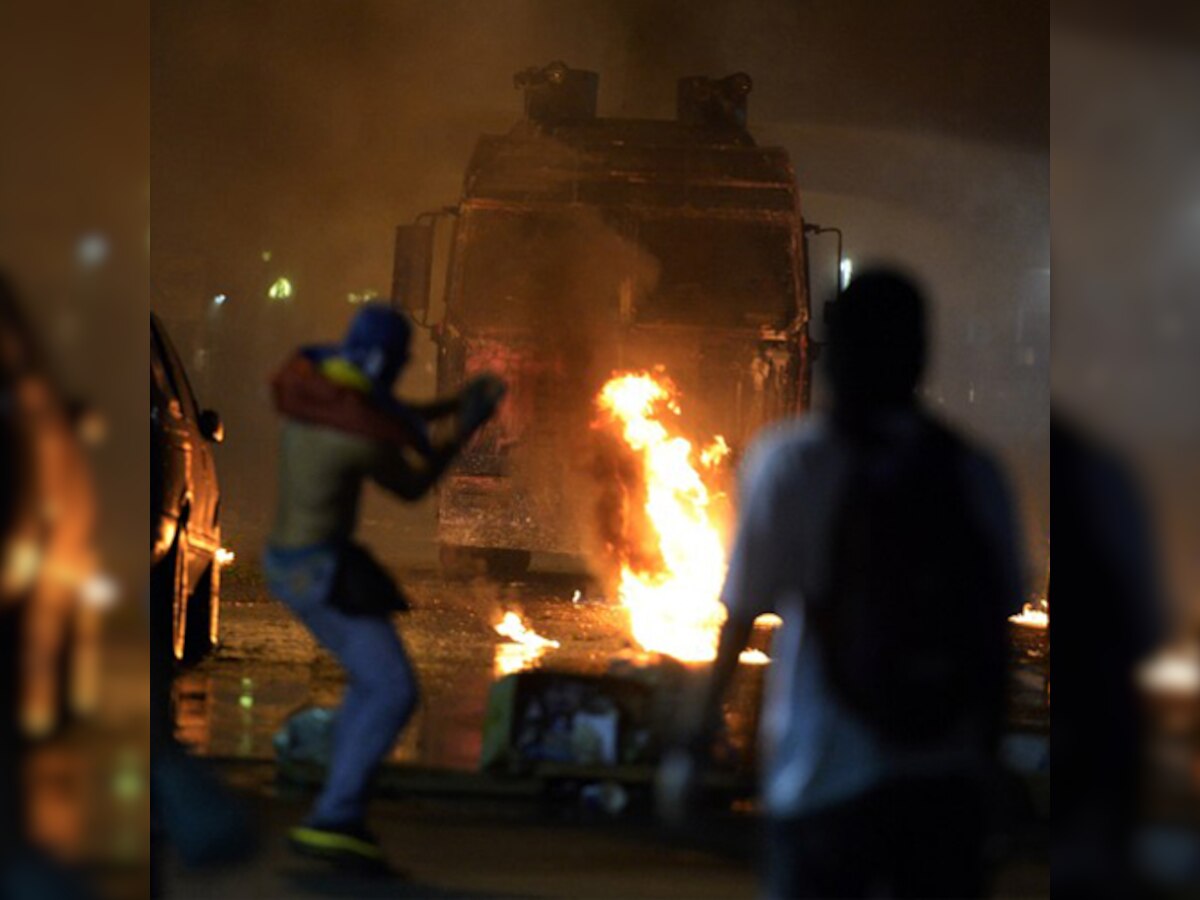 Venezuela clashes continue, protesters burn effigy of President Nicolas Maduro