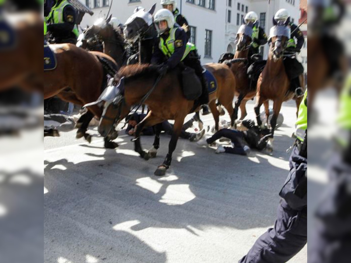 Police horses trample rival protesters at far right rally in Sweden
