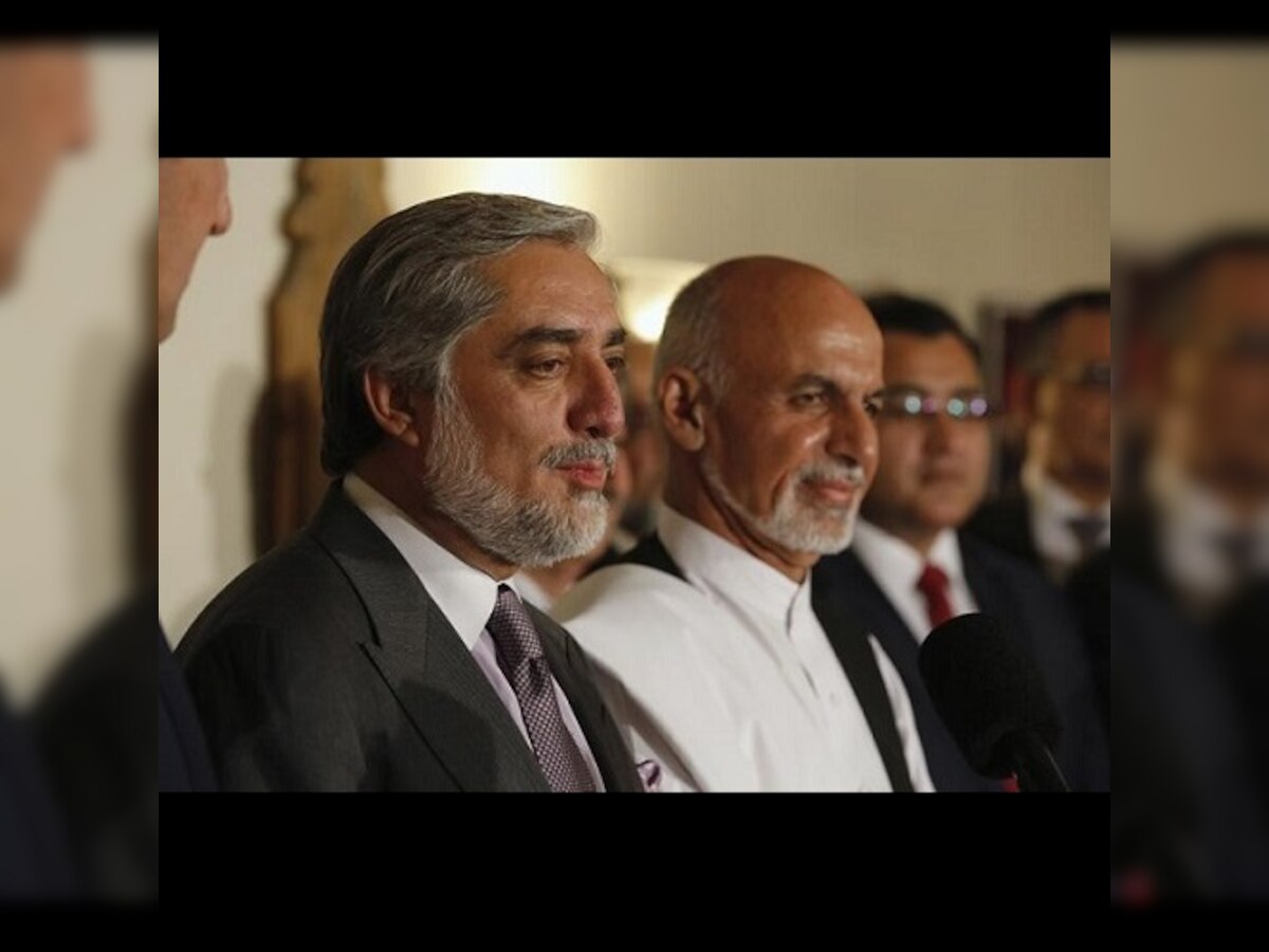Afghan presidential rivals at last reach power-sharing deal after disputed vote