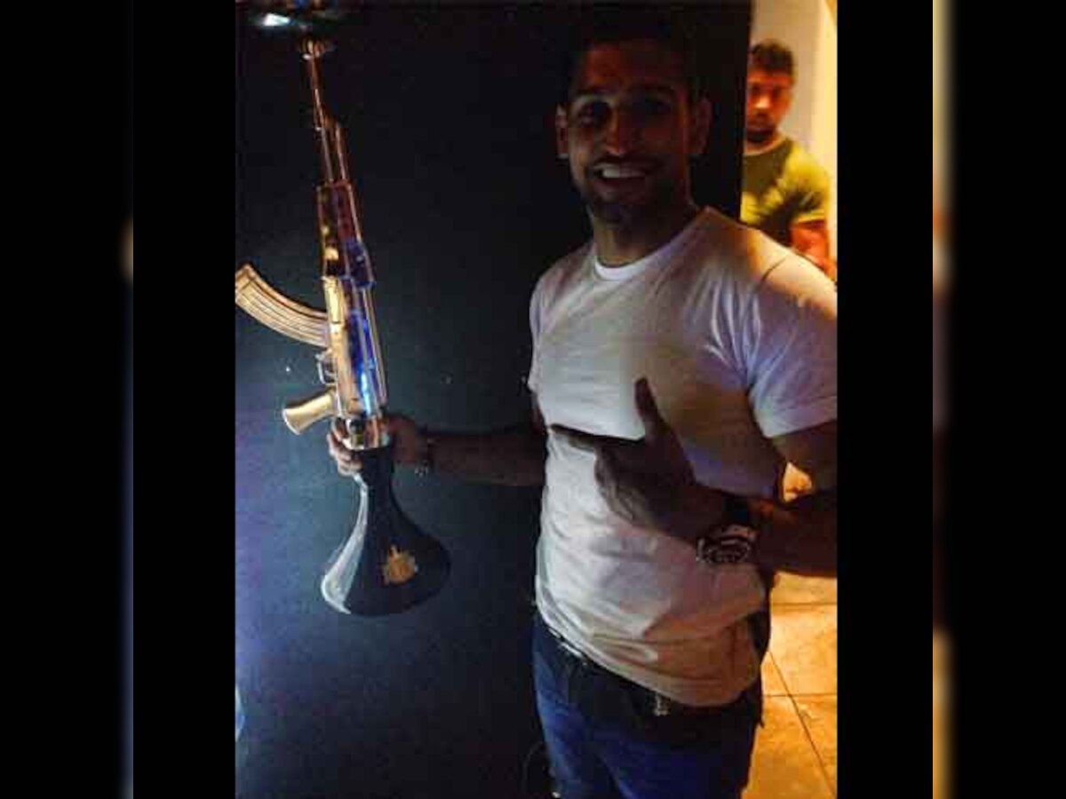 Boxer Amir Khan sparks outrage for posing with AK47-shaped shisha pipe