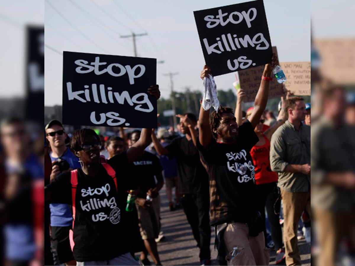 Protests persist in Ferguson, US; suspects sought in shootings of two Missouri officers