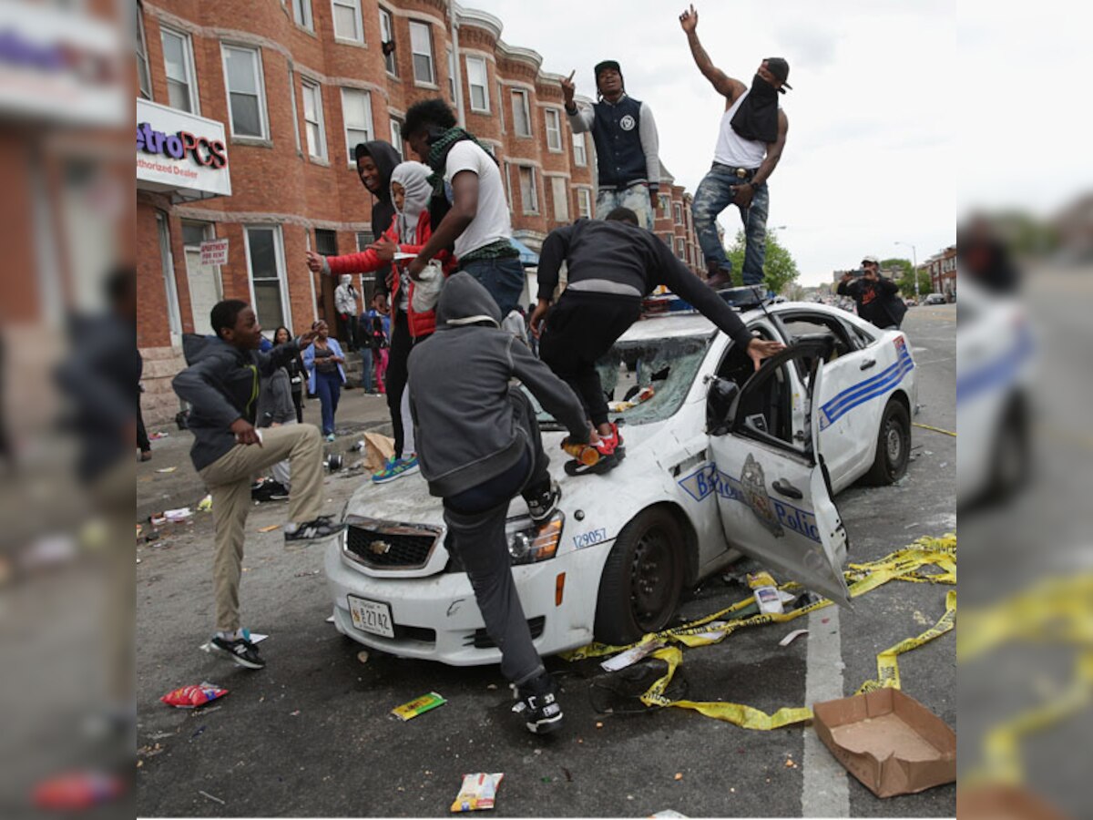15 officers injured as Baltimore erupts in riots after funeral of African American who died in police custody