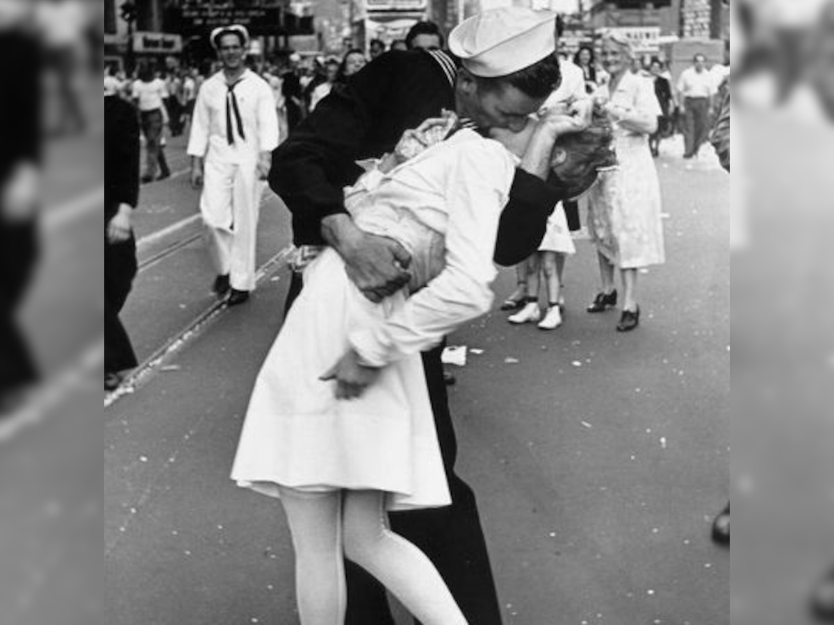 Hundreds of couples kiss at Times Square to reenact famous photograph celebrating end of World War II