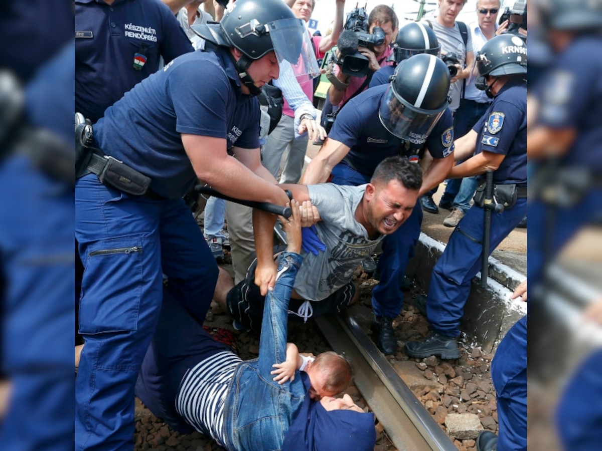 Confrontation as Hungary police force refugees off train