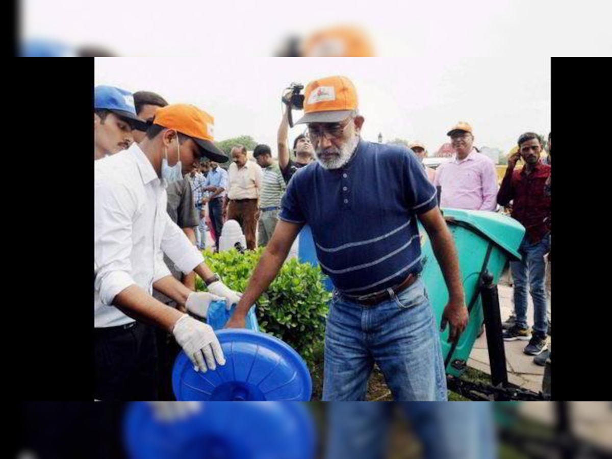 Tourism Minister Alphons Kannanthanam cleans India Gate lawns