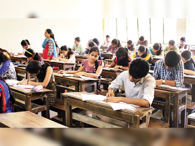 Indian students taking a competitive exam in an examination hall