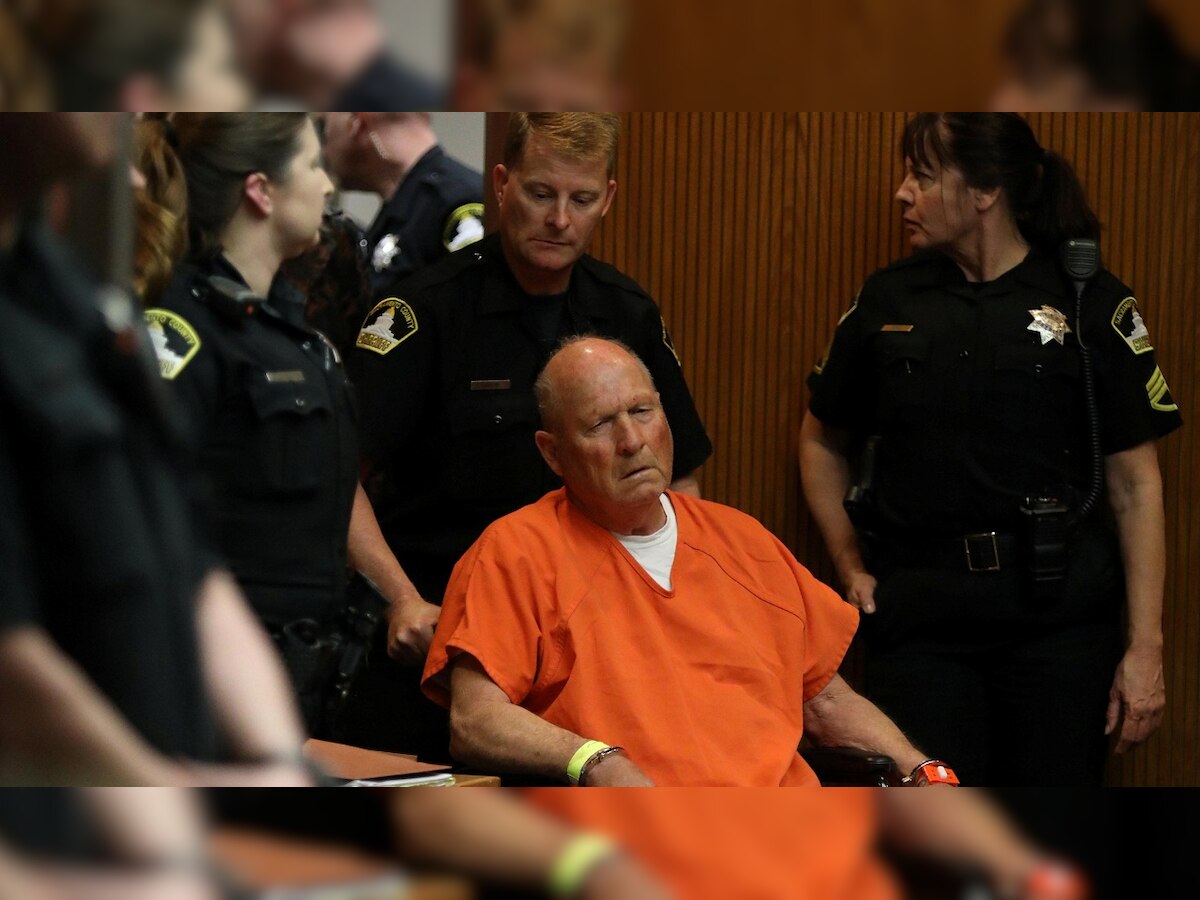 Ex-policeman charged with murder and rapes makes court appearance in wheelchair