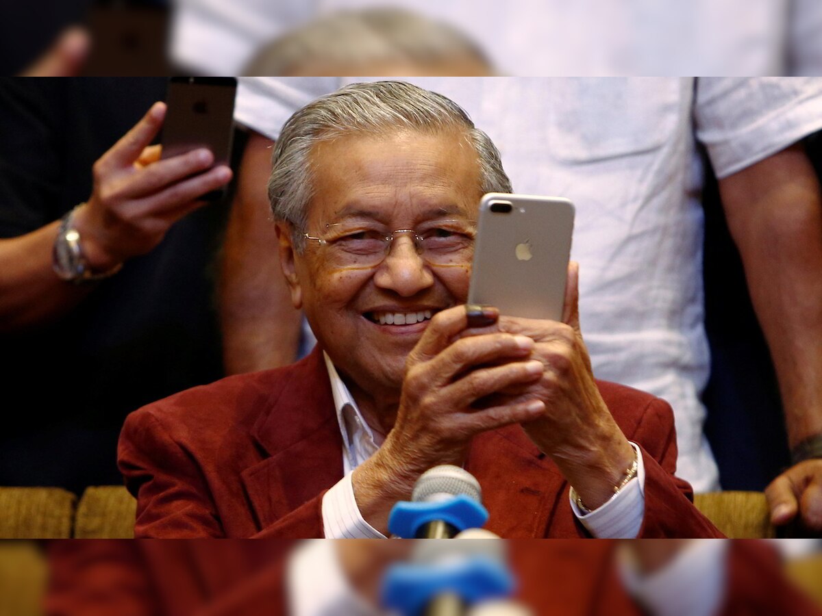 Veteran 92-year-old leader and ex-PM Mahathir Mohamad leads Opposition coalition to victory in Malaysian election