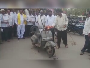 Watch: To protest against fuel price-hike, TDP worker sets his own two-wheeler on fire