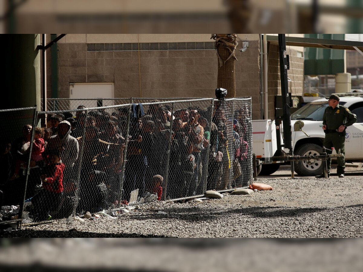 Migrants held in El Paso, Texas, enclosure as surge overwhelms city