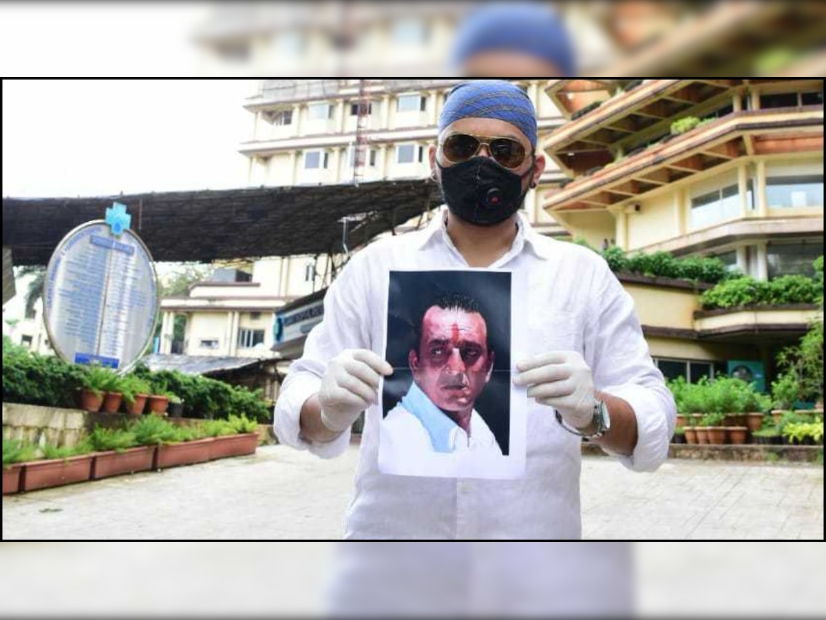 Fan poses with Sanjay Dutt's photo outside Lilavati hospital