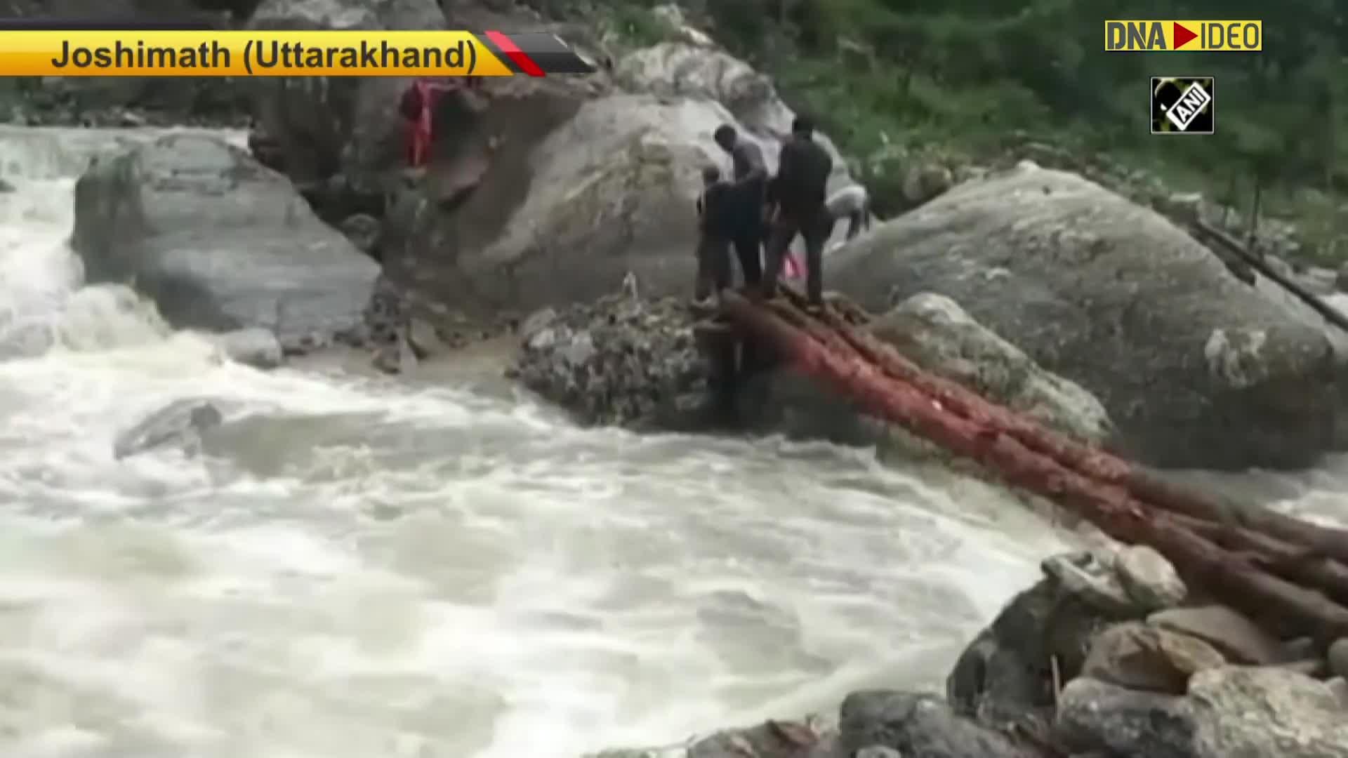 Watch Locals use makeshift bridge to cross river stream