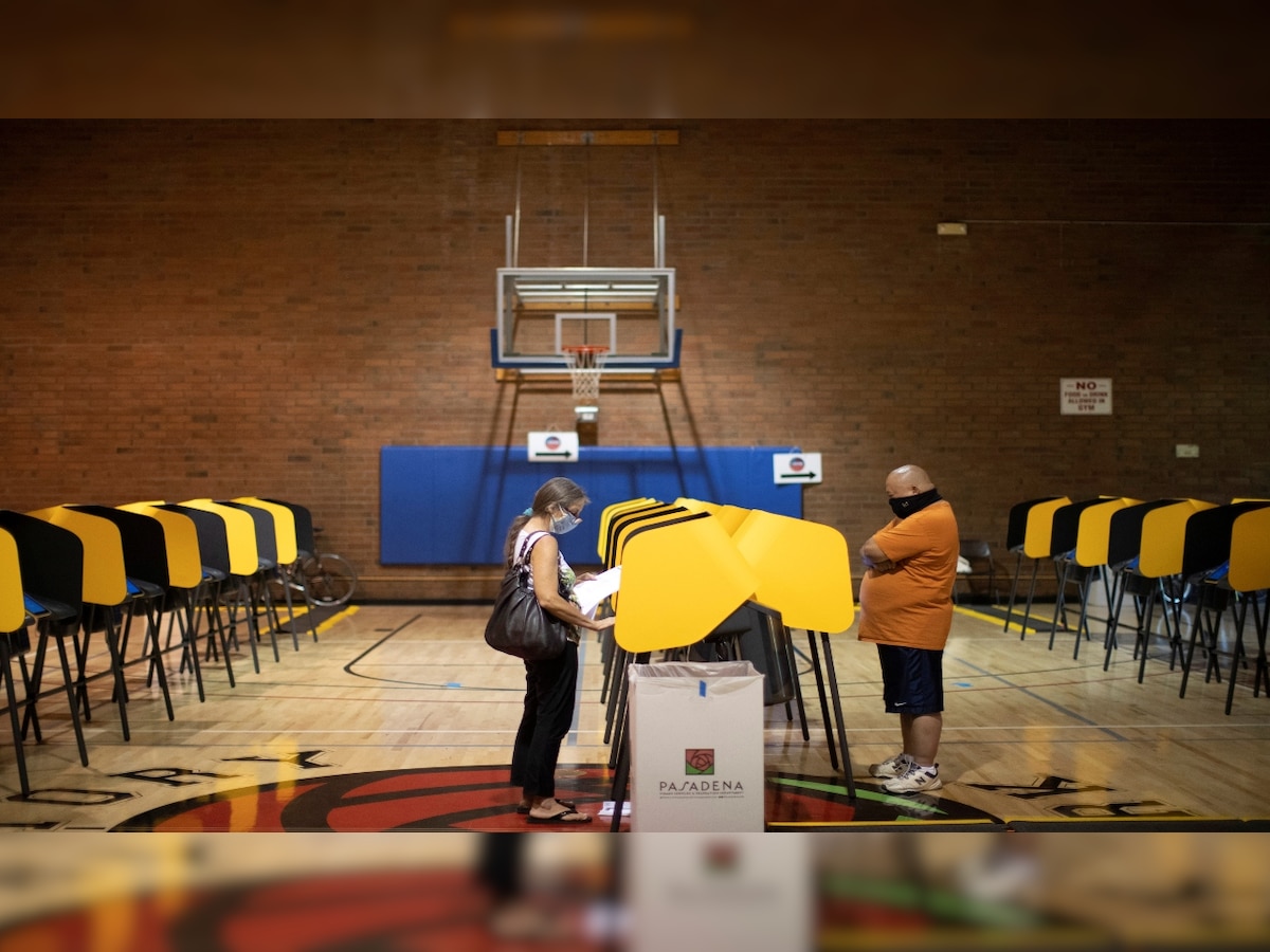 US Elections 2020: Anxious Americans vote with faces masked, stores boarded up