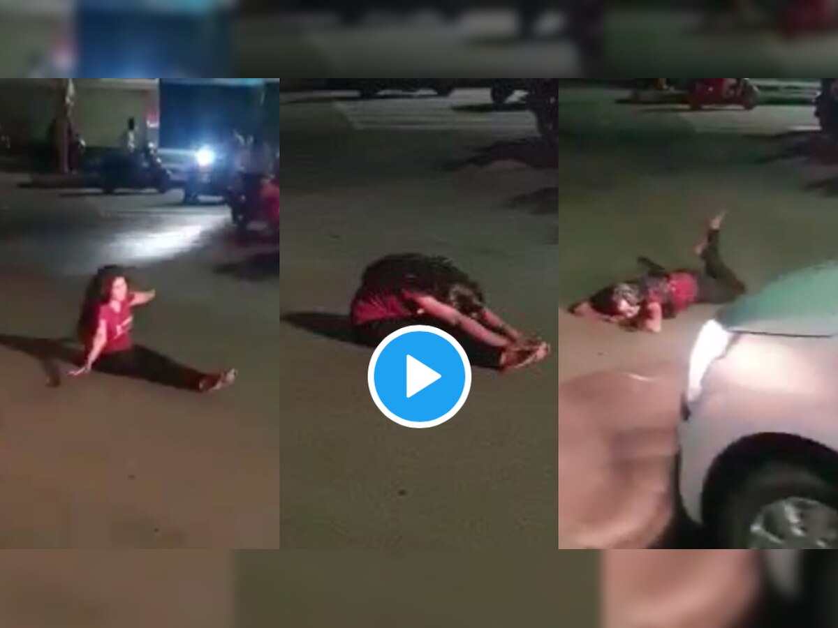 Drunk woman lays in the middle of the road, disrupts traffic - WATCH viral video