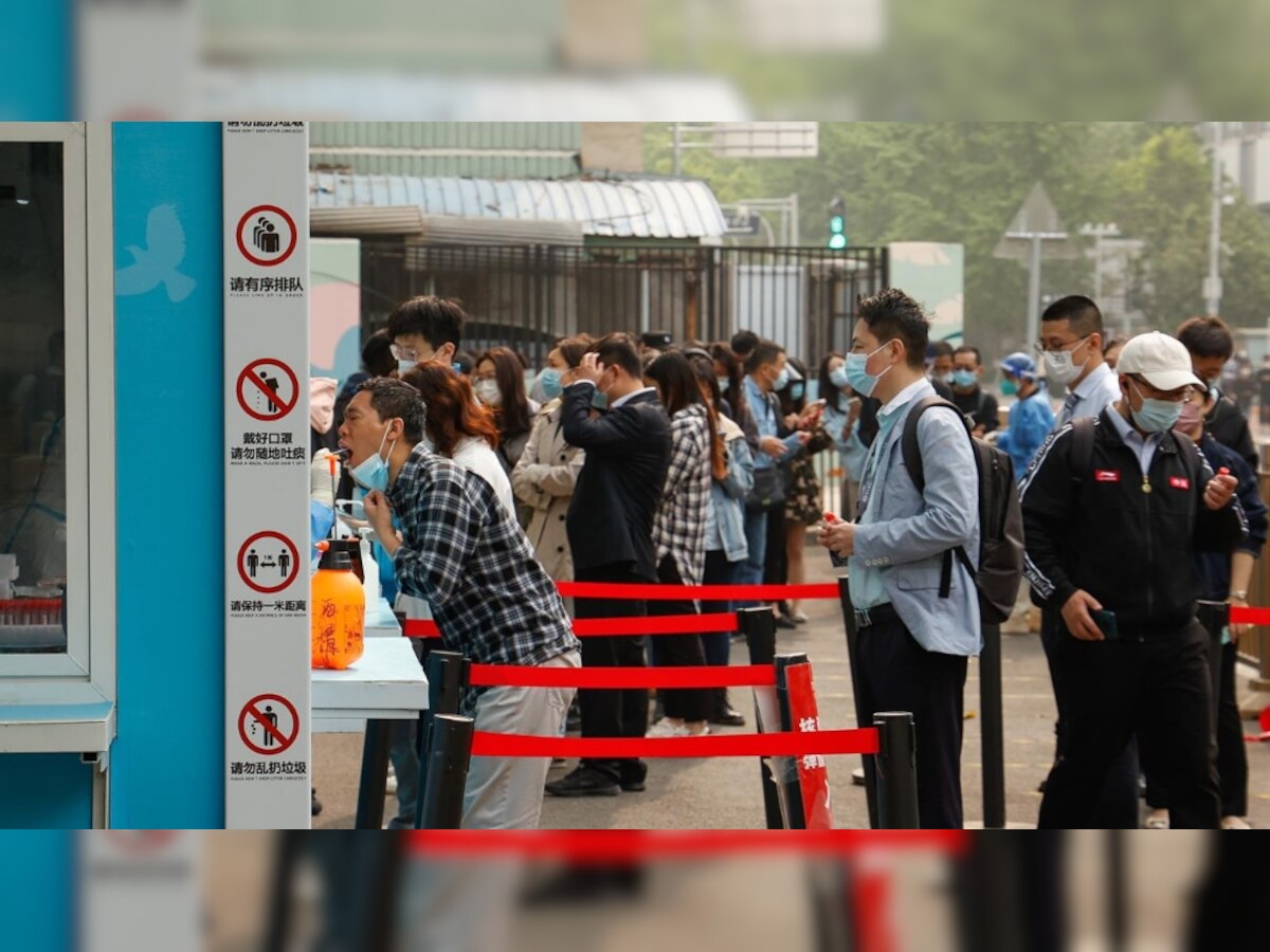 Beijing shoppers clear store shelves as mass testing begins after Covid surge