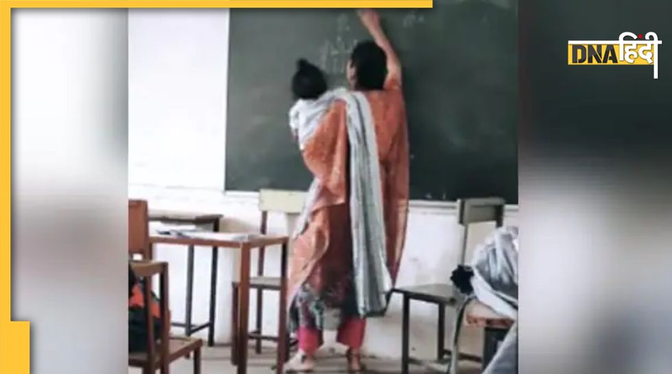 VIRAL TEACHER: बच्चे को गोद में लिए क्लास में पढ़ाती दिखी टीचर, लोग