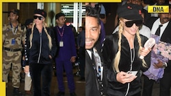 Paris Hilton arrives carrying portable fan in hand at Mumbai airport, poses for paps