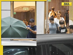 Shah Rukh Khan reaches Mumbai after being discharged from Ahmedabad hospital, hides from paps behind umbrella