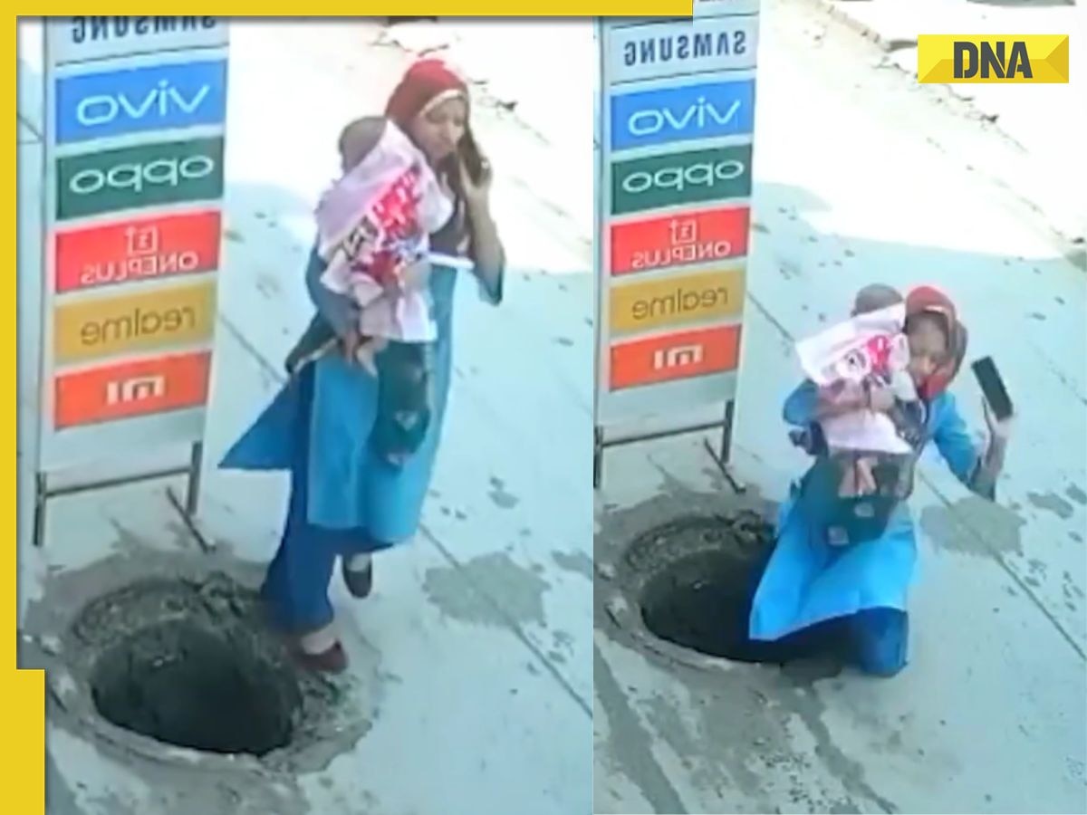 Woman talking on phone falls into open manhole with baby, shocking viral video raises safety concerns 