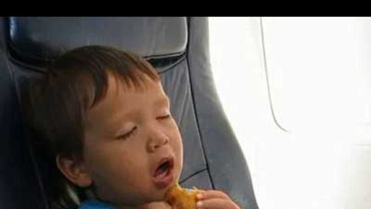 Video of toddler falling asleep as he eats chicken fingers on a flight