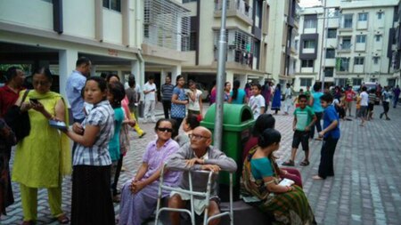 Residents in a housing colony in Siliguri evacuate their homes after feeling earthquake tremors.