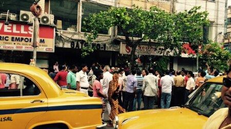 Residents in Kolkata gather around after earthquake tremors forced people to evacuate.