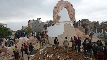 Nepalese rescue members gather at the collapsed Darahara Tower in Kathmandu on April 25, 2015.