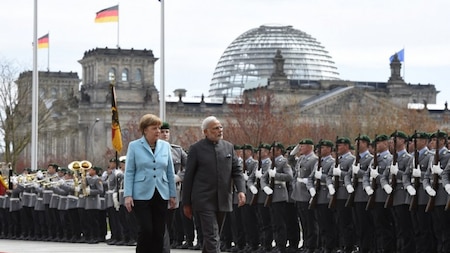 German Chancellor Angela Merkel and Indian Prime Minister Narendra Modi inspect an honor guard before talks at the Chancellery in Berlin April 14, 2015. AFP.