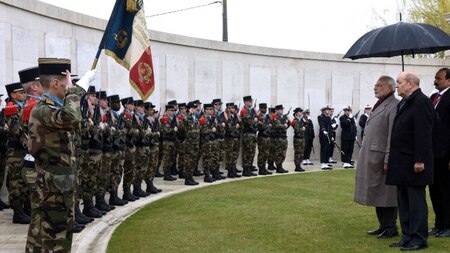 Indian Prime Minister Narendra Modi (2ndR) and French minister Jean Yve le Drian (R) greet French soldiers during a ceremony on April 11, 2015.