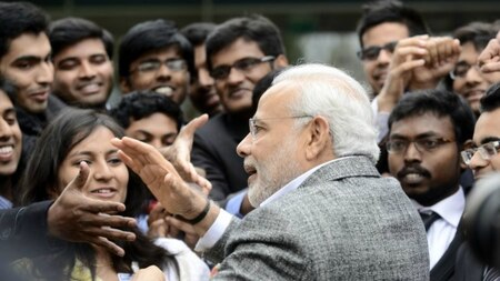 Indian Prime Minister Narendra Modi (C) salutes a delegation of Indian people studying in the French Midi-Pyrenees region as he visits the National center for space studies (CNES) on April 11, 2015 in Toulouse.