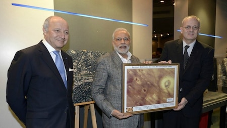Indian Prime minister Narendra Modi (C) receives a gift from Jean-Yves Le Gall (R), President of the French Space agency CNES.