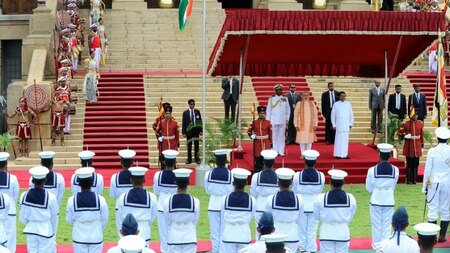 Indian Prime Minister Narendra Modi (6R) and Sri Lankan President Maithripala Sirisena (4R) stand to attention during a welcoming ceremony at the Presidential Secretariat in Colombo on March 13, 2015.