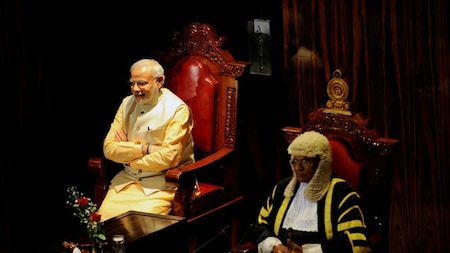 Indian Prime Minister Narendra Modi (L) sits next to the Sri Lankan Speaker of Parliament Chamal Rajapaksa after addressing the Sri Lankan parliament in Colombo on March 13, 2015.