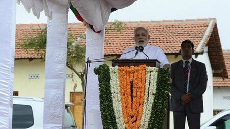 Indian Prime Minister Narendra Modi (C) speaks during a ceremony to hand over Indian-funded houses to Tamils displaced or made destitute by fighting in Jaffna, some 400 kilometres (250 miles) north of Colombo on March 14, 2015.
