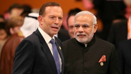 Australia's Prime Minister Tony Abbott walks with India's Prime Minister Narendra Modi to the plenary session of the G20 Summit in Brisbane on November 15, 2014.