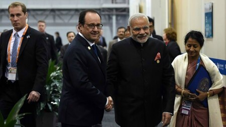 France's President Francois Hollande (2nd L) greets Indian Prime Minister Narendra Modi.