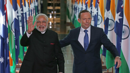 India's Prime Minster Narendra Modi (L) and Australian Prime Minister Tony Abbott leave the House of Representatives.