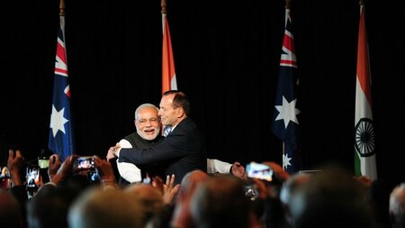 Indian Prime Minister Narendra Modi (L) is hugged by Australian Prime Minister Tony Abbott.