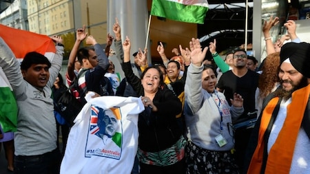 Supporters of India's Prime Minister Narendra Modi dance outside Southern Cross station in Melbourne.