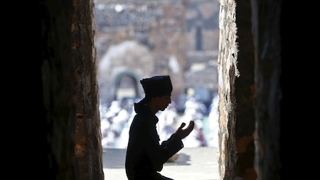 A Muslim man offers Eid al-Adha prayers in New Delhi