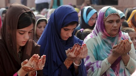 Muslim women perform their prayers for Eid al-Adha in Pakistan