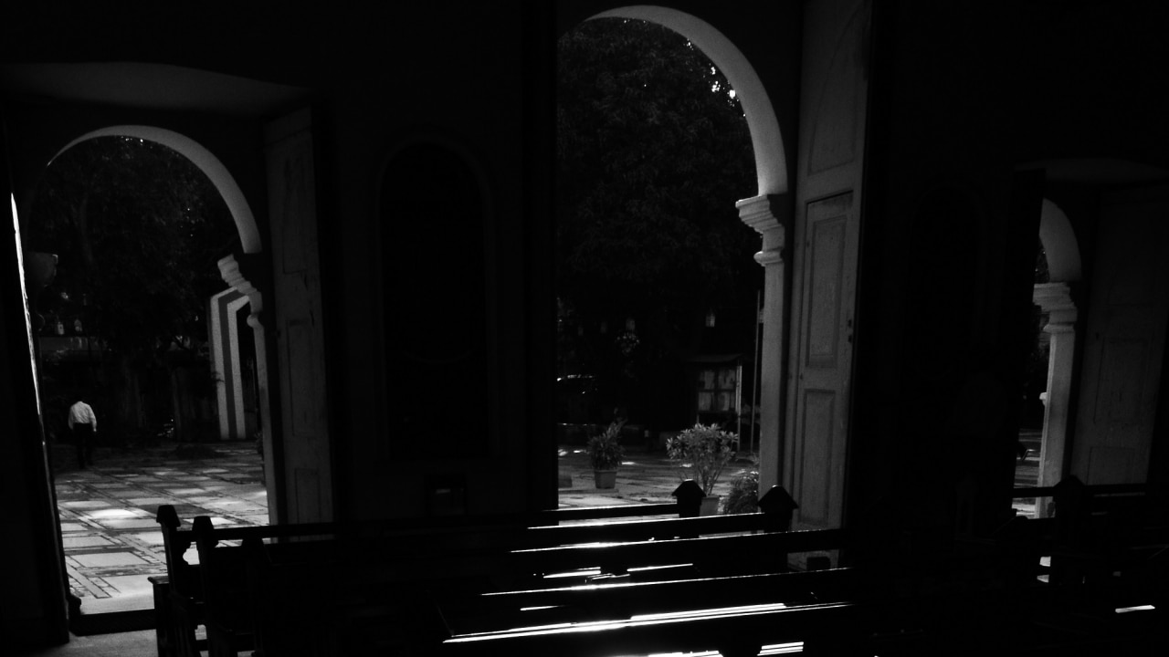 First rays of light cast shadows inside the church