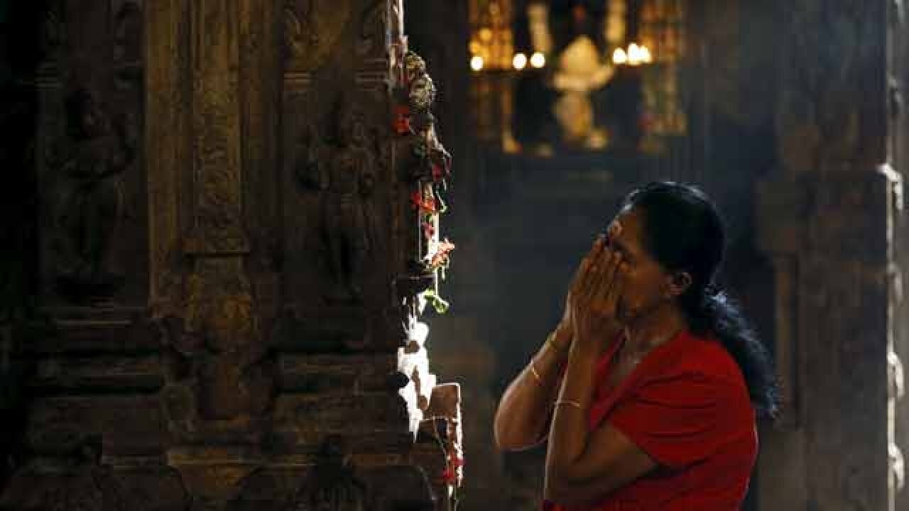 A devotee prays during Pongal festival