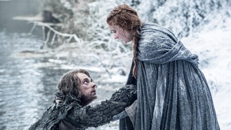 Alfie Allen as Theon Greyjoy and Sophie Turner as Sansa Stark