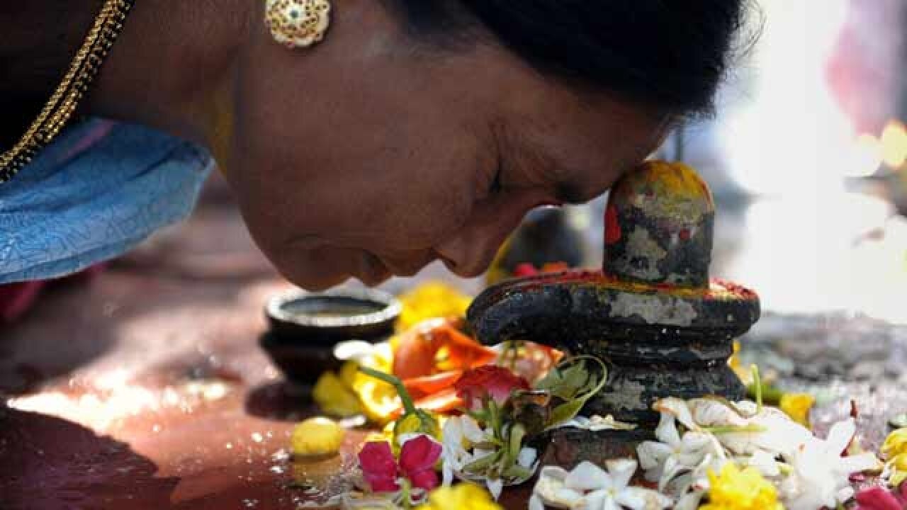 Devotee taking blessings of Lord Shiva