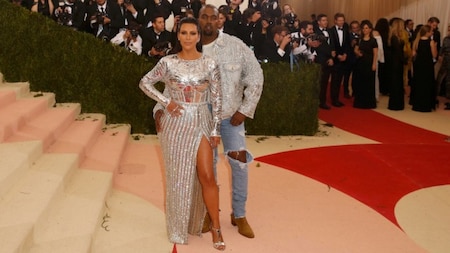 Kanye West (R) and wife Kim Kardashian